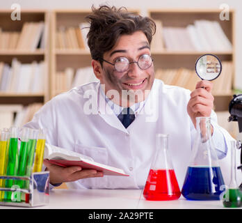 The mad crazy scientist doctor doing experiments in a laboratory Stock Photo