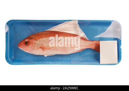 Red snapper raw fish in a styrofoam container at the supermarket. Isolated on white background. Stock Photo