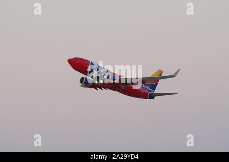 'Tennessee One' Southwest aircraft (Boeing 737) shown taking off from the Los Angeles International airport (LAX) right after sunset. Stock Photo