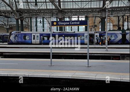 Passengers boarding Scotrail Class 380 Desiro electric trains at Glasgow Central Station Stock Photo