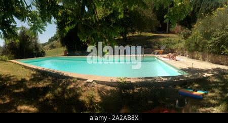 Garden pool and woman relaxing in rural Tuscany Stock Photo