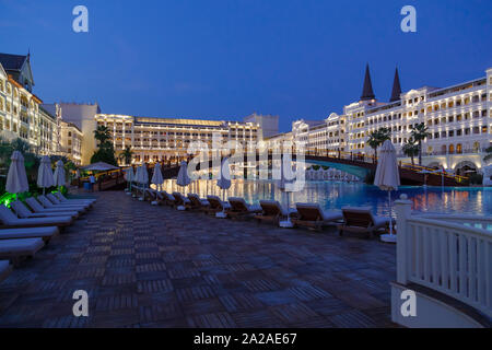 ANTALYA, TURKEY - SEPTEMBER 12, 2019: Exterior and swim pool at night of Titanic Mardan Palace luxury hotel, the most expensive European's resort. Stock Photo