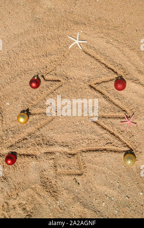 Christmas tree made of shells in the sand. Selective focus. nature. Stock Photo