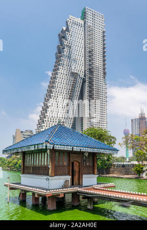 The Seema Malaka Temple on Lake Beira sits against a background of urban development in the Sri Lankan capital of Columbo. Stock Photo