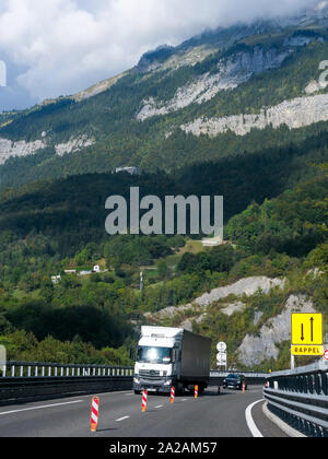 Trucks drive on the Egratz viaduct, Chamonix-Mont-Blanc valley, Haute-Savoie, France Stock Photo