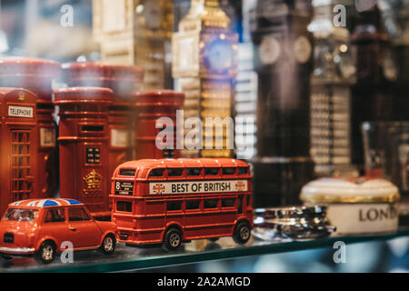 London, UK - August 30, 2019: View through the window of London red post box and red bus souvenirs on sale. London is one of the most visited cities i Stock Photo