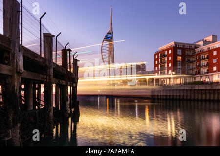 The Spinnaker tower in Portsmouth, Hampshire UK with the light trails from a passing ferry in the foreground Stock Photo