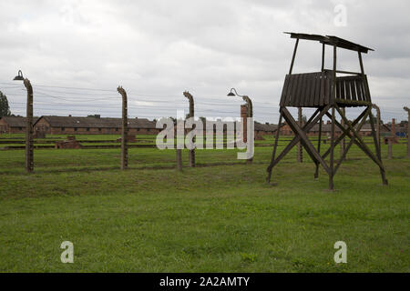 Guard tower and electric fences, Auschwitz-Birkenau, former German Nazi concentration and extermination camp, Oswiecim, Poland. Stock Photo