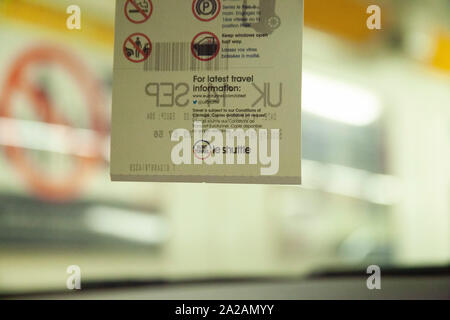 On-board the Eurotunnel, with a shot of the hanging ticket required to board inside a vehicle - nice blurred background behind, showing the carriage. Stock Photo