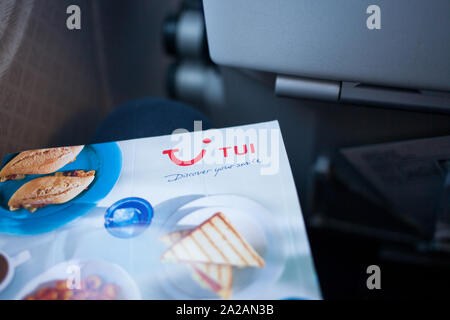 tui close menu board flight branding cabin within showing natural brand using fin passenger tail aircraft logo holding light man