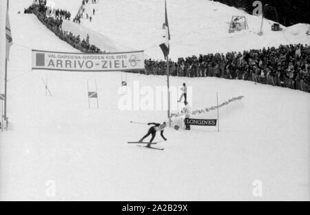 The Alpine World Ski Championships took place in Val Gardena between 7.2.1970 and 15.2.1970, and it had been the only World Cup so far, the results of which were included in the Alpine Ski World Cup. Photo of an athlete finishing his downhill race and crossing the finish line. Stock Photo
