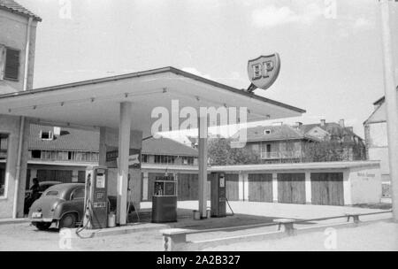 The picture shows a BP gas station in a rural region of Austria, along with some garages. The sign on the flat roof of the gas station and the advertising sign at the entrance show the BP logo from this period. Stock Photo