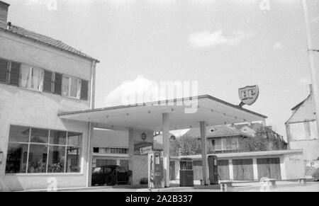 The picture shows a BP gas station in a rural region of Austria, along with some garages. The sign on the flat roof of the gas station and the advertising sign at the entrance show the BP logo from this period. Stock Photo