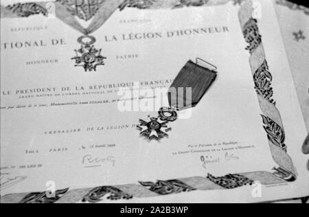 Anna Stadler from Gundelfingen was the first German woman to be awarded the Order of the French Legion of Honor in 1959. During the Second World War, she looked after French prisoners of war in secret and helped some of them to flee shortly before the end of the war. The picture shows the certificate and medal. Stock Photo
