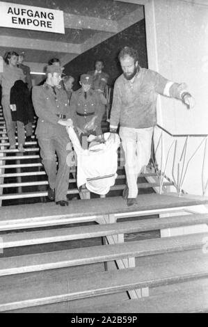 Members of the Ausserparlamentarische Opposition (extra-parliamentary opposition APO) gained access to an election campaign of the CSU with forged tickets in the Bayernhalle in Munich. Photo of police officers removing members of the APO on a staircase leading to the hall. Stock Photo