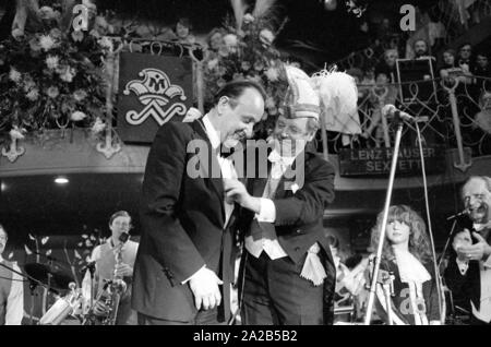 The annual Karl Valentin Order of the Munich carnival society Narrhalla was awarded to Hans-Dietrich Genscher in 1982. Photo of Genscher with the president of the society on stage at the award ceremony. Stock Photo