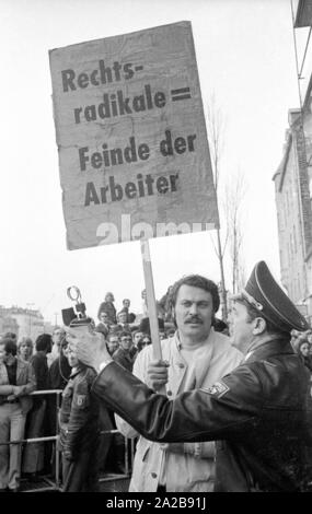 On 03.04.1971 the neo-Nazi party 'German People's Union' (today NPD) organized its first mass rally in Schwabinger Braeu in Munich, under the direction of the publisher Gerhard Frey.  There was a protest rally with leading politicians, a counter-demonstration and blockade of the building. Pictured: A protester holds up a sign saying 'Right Radical = Enemies of the Workers'. Stock Photo