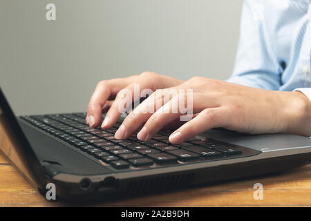 Businesswoman's hands typing on laptop keybord. Stock Photo