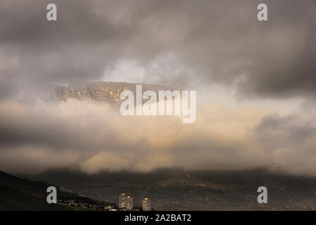 A break in the cloud reveals part of Table Mountain in the South African Atlantic port city of Cape Town Stock Photo