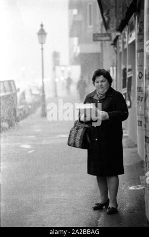 As part of a campaign against narcotics in Munich, Ms. Baumann distributes the publication of the Süddeutsche Zeitung 'Das vergiftete Gehirn' ('The Poisoned Brain') to passers-by. Stock Photo