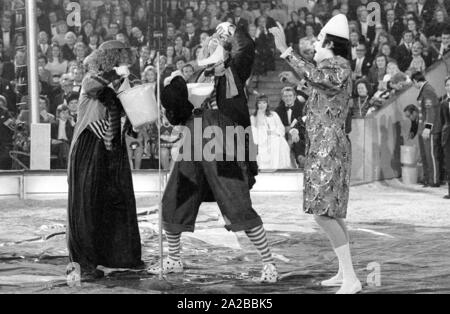 Clowns perform a classic clown act with a funnel in the TV show 'Stars in the Manege' in 1971. Stock Photo