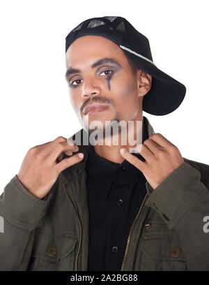 African musician singer with casual modern clothing and a cap wearing makeup, rock Stock Photo