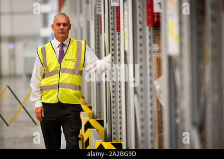 Director of Programmes NHS Wales Mike Roscrow beside aisles of medical supplies, which are being stockpiled as part of Brexit preparations at a NHS Wales warehouse in South Wales. The warehouse is storing extra medical devices and consumables to ensure health and social services continue to run smoothly in the event of a no-deal Brexit. Stock Photo