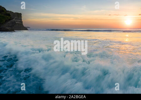 Large tropical waves crashing at sunset in Bali Stock Photo