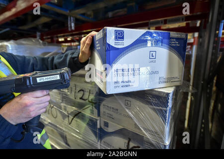 A warehouse worker scans medical gloves, which are being stockpiled as part of Brexit preparations at a NHS Wales warehouse in South Wales. The warehouse is storing extra medical devices and consumables to ensure health and social services continue to run smoothly in the event of a no-deal Brexit. Stock Photo