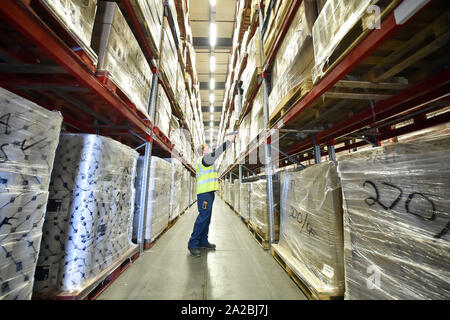 A warehouse worker scans pallets of medical supplies, which are being stockpiled as part of Brexit preparations at a NHS Wales warehouse in South Wales. The warehouse is storing extra medical devices and consumables to ensure health and social services continue to run smoothly in the event of a no-deal Brexit. Stock Photo