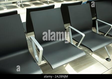 Empty chairs in an airport terminal.