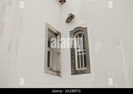 A couple of narrow windows in the corner of a ruined wall (Madeira, Portugal) Stock Photo