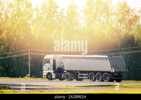 Big dump truck goes on country highway Stock Photo