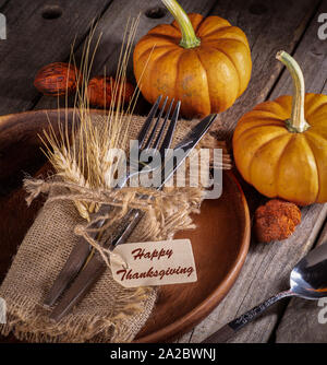 Autumn place setting and mini pumpkins on a rustic wooden table Stock Photo