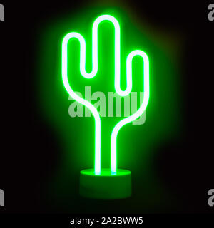 Neon green cactus LED lamp on black background. Stock Photo