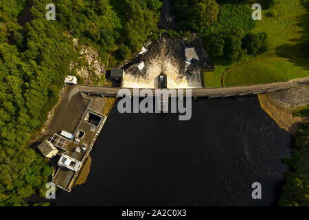 Water flowing over the Meig Hydro Electric Dam in Highland Scotland. Stock Photo