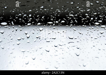 Large raindrops on glass. Dark black and gray gradient background Stock Photo