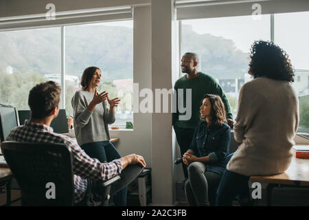 Diverse designers discussing a project during an office meeting Stock Photo