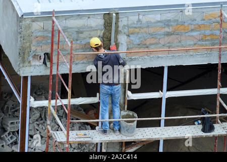 Construction worker on scaffold. Batumi, Georgia Stock Photo