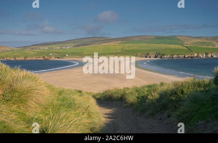 The sand spit, or tombolo, that joins St Ninian's Isle to Mainland Shetland - taken from the island looking across to the farmland of south Mainland. Stock Photo