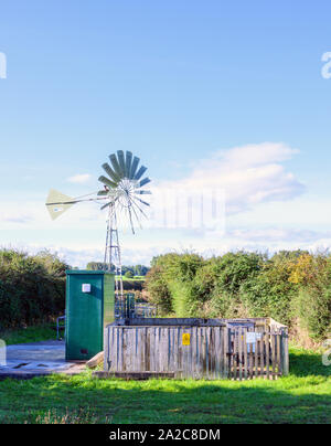 A water pumping station on the outskirts of Lytham St Anne's, Lancashire, UK. The pump runs on electricity generated by a wind turbine Stock Photo