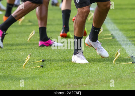 Horst, Netherlands - June 27, 2018: The feet of PAOK players and football training equipment during the training of the team on the pitch Stock Photo