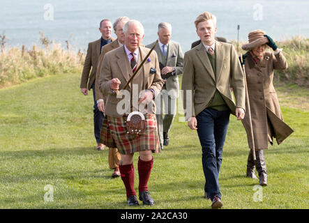 The Prince of Wales, known as the Duke of Rothesay while in Scotland, is accompanied by castle owner George Pearson (front right), during a visit to Dunnottar Castle, the cliff top fortress which was once the home of the Earls Marischal, near Stonehaven. Stock Photo