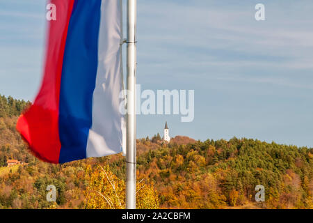 The flag of Slovenia flies against a beautiful autumn background in Zrece Stock Photo