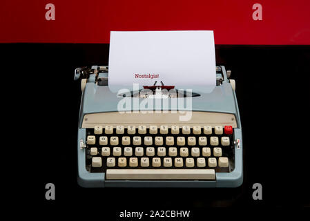 Text of nostalgia on paper with old manual typewriter in black background Stock Photo