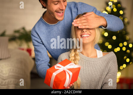 Man giving Christmas present to his girlfriend Stock Photo