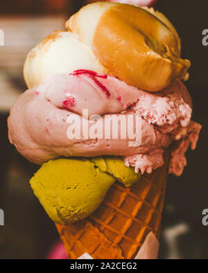 Delicious gelato, organic dairy and homemade recipe concept - Ice cream cone melting outdoors in summer, sweet dessert food on holiday Stock Photo