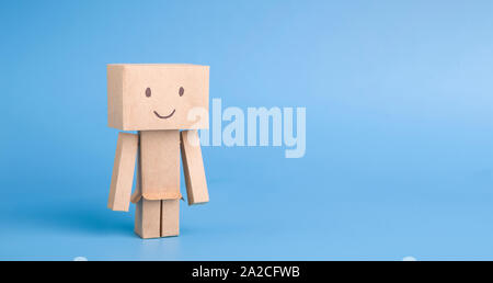 Handmade cardboard robot on blue panorama background Stock Photo
