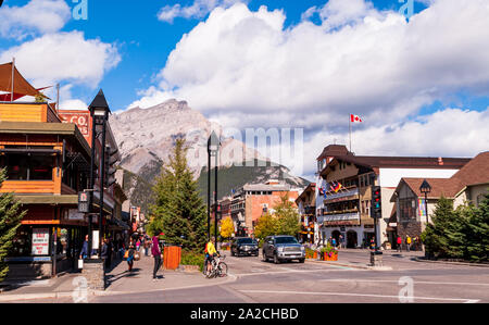 Looking down Banff Avenue from Buffalo Street towards a mountain at the end of town on a sunny fall day, Banff, Alberta, Canada Stock Photo