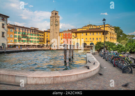 RIVA DEL GARDA, ITALY - JUNE 6, 2019: The harbor and Torre Apponale tower. Stock Photo